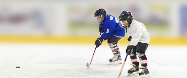 hockey players with a puck skating