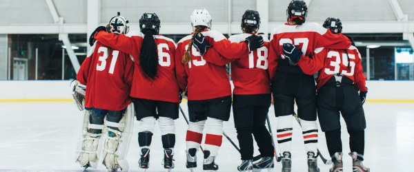 hockey players with a puck skating