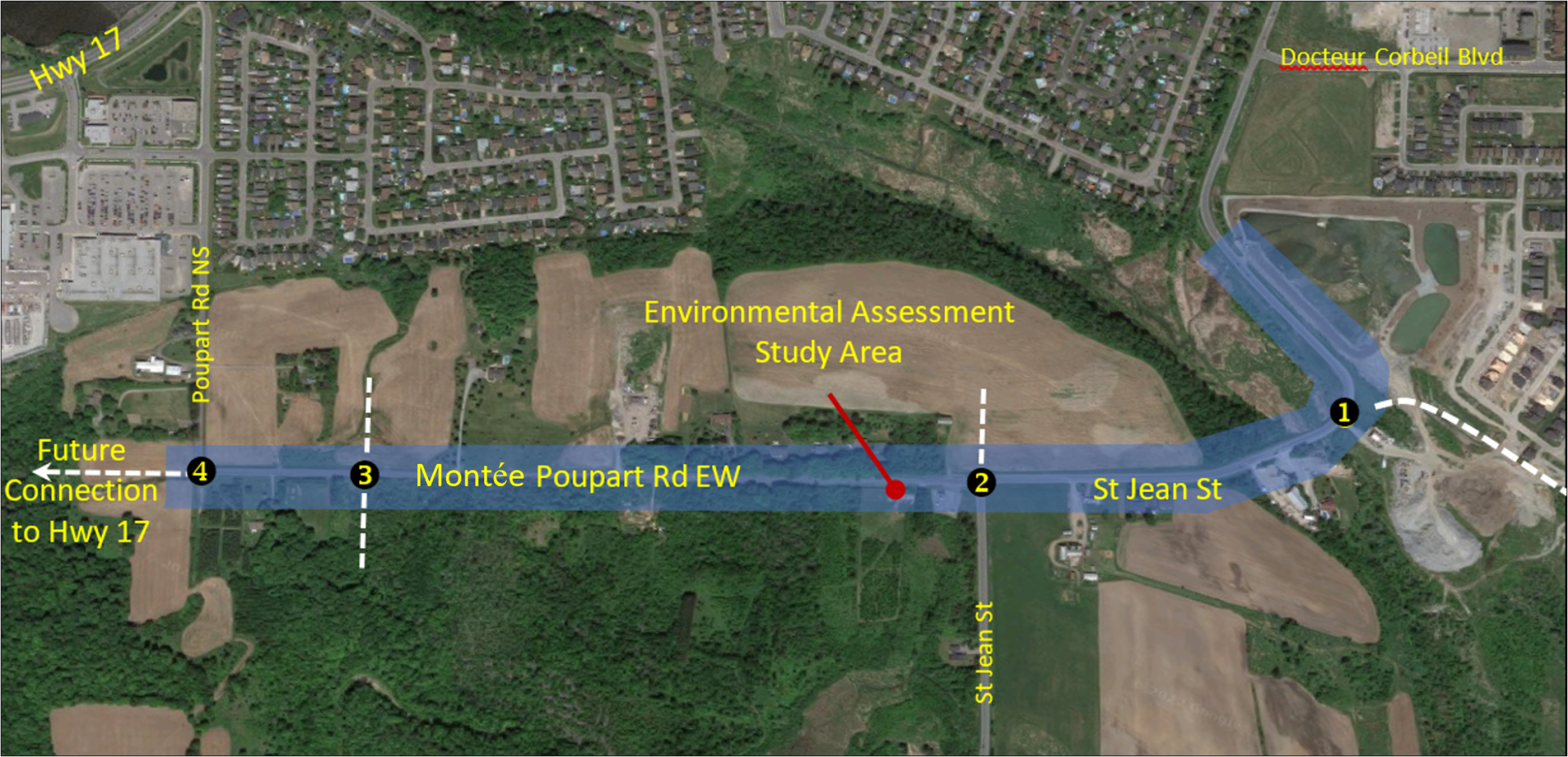 Aerial view of a highway project route through a rural area with fields and trees.