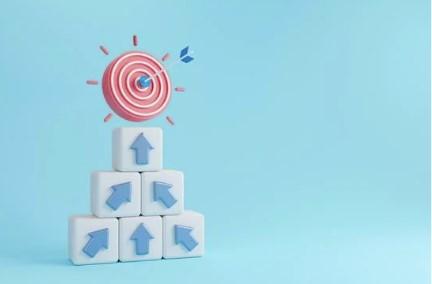 Cible rouge au-dessus de cubes avec flèches bleues sur fond bleu.